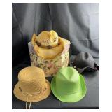 Collection of assorted straw and woven hats in a