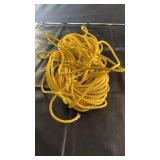 Coil of yellow twisted poly rope suitable for