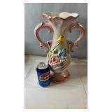 Decorative ceramic vase featuring dual handles,