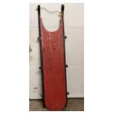 Vintage wooden toboggan sled with red painted