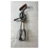 Vintage hand-crank egg beater mixer with metal