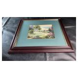 Framed countryside cottage print featuring a