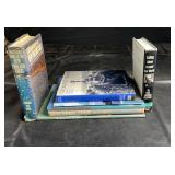 Mixed book lot featuring titles such as Sailing