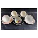 Assorted vintage teacups and saucers featuring a