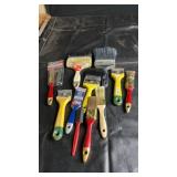 Assorted paint brushes and scrapers in various