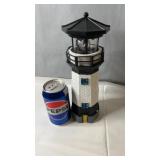 Solar-powered lighthouse dï¿½cor piece with