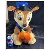 Plush Paw Patrol character (Chase) holding a