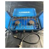 Vintage propane camp stove in a blue metal
