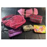 Collection of handbags, cosmetic bags, and travel