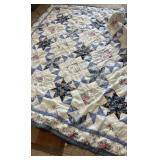Handmade patchwork quilt sized for a double bed,