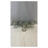 Glass storage jar collection featuring four