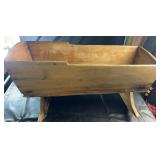 Vintage wooden cradle planter box on rocker-style