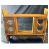 Wooden wall-mounted shelf featuring heart-cutout