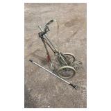 Vintage folding golf push cart featuring a
