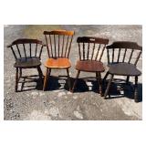 Collection of four mismatched wooden chairs in a
