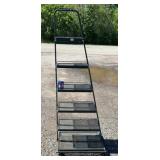 Black metal tiered display shelf with six mesh