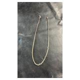 Sterling silver necklace marked 925. Features a