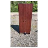 Tall storage cabinet with a rich cherry-finish