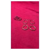 Three pairs of hoop earrings in varying sizes and