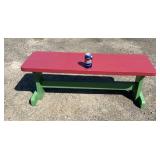 Painted wooden bench featuring a red plank-style