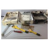 Painting supplies including three paint trays, a