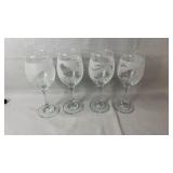 Set of four stemmed wine glasses featuring