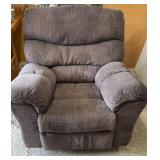 Brown upholstered rocking recliner chair with a
