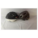 Pair of bicycle helmets in black/white and gray.