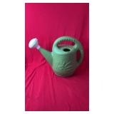 Plastic watering can with top fill opening and