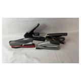 Four desktop staplers from mixed brands and