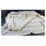 Cream-coloured knit throw blanket with a