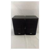 Pair of black RCA bookshelf speakers with