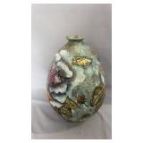 Decorative art vase featuring a raised floral