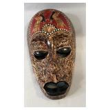 Carved decorative face mask featuring detailed