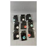 Nine pairs of pierced stud earrings in a variety