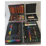 Two art sets in carrying cases with coloured