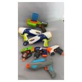 Collection of toy blasters including Nerf,