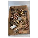 Box of plumbing supplies with copper elbows, tees