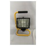 Portable work light with yellow tubular stand,