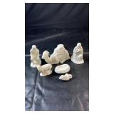 Six- piece white nativity set featuring figures,