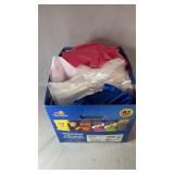 Box filled with assorted fabric pieces in a