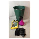 Green metal garbage can , vinyl rain poncho, hand