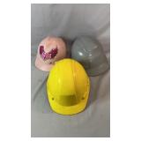 Three hard hats in assorted colors including