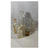 Collection of six glass bottles and one small