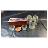 Three glass canning jars with lids, wooden