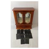 Wood-finish jewelry box featuring decorative