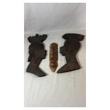 Two hand-carved decorative profile wall plaques