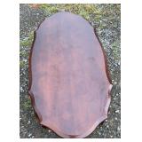 Wood coffee table featuring an elongated top with
