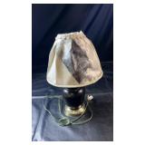 Small table lamp featuring a dark rounded base