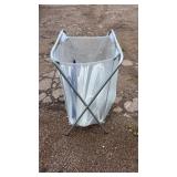 Mesh laundry hamper on a folding metal frame,